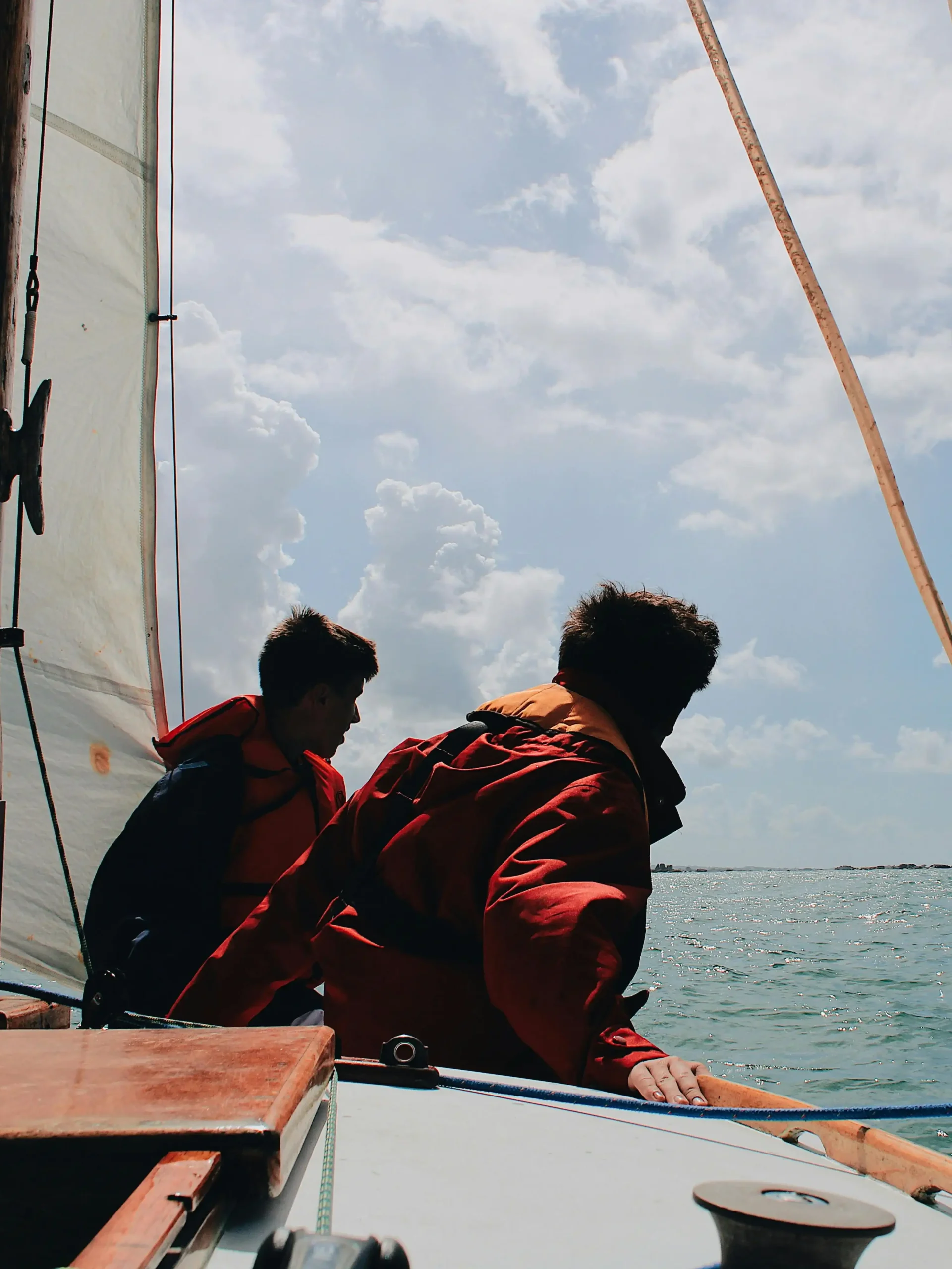 pexels-photo-3098596-3098596 Two sailors on a sailboat enjoying a sunny day on the ocean.